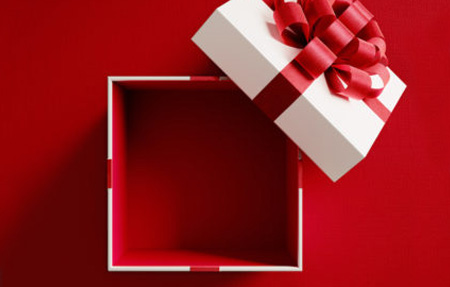 a square gift box with big red bow sits open