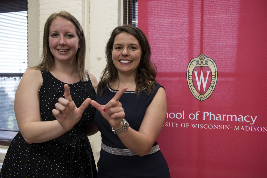 Olivia Fahey and Joanne Kuznicki holding up "W"'s