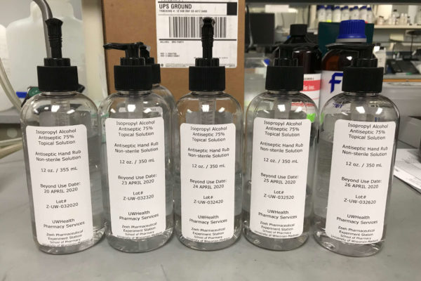 Line-up of hand sanitizer bottles in a lab
