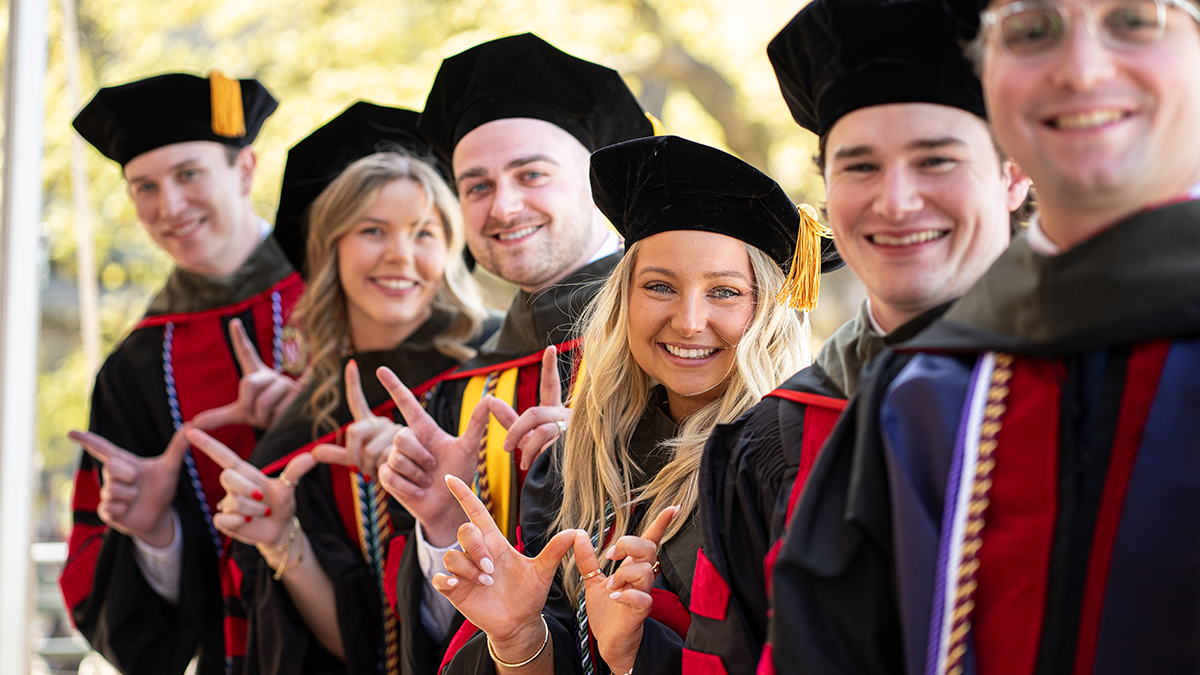 Students gathered together in graduation regalia