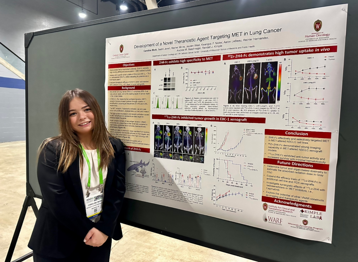 Caroline Mork stands next to a research poster