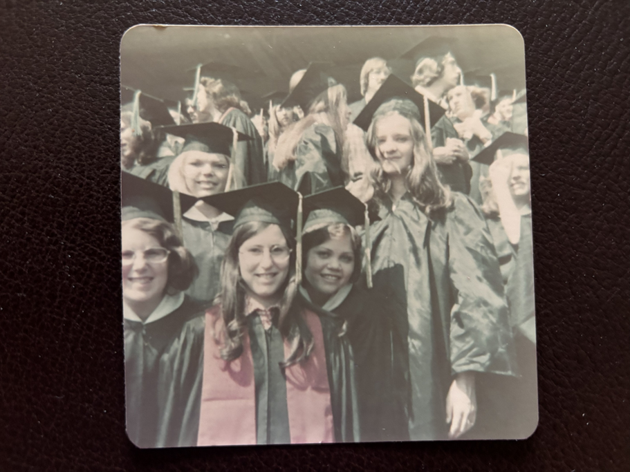 A group photo of students in graduation robes and hats