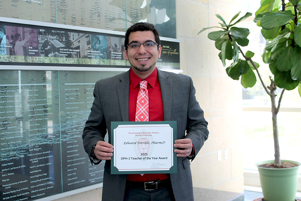 Ed Portillo holding a Teacher of the Year certificate