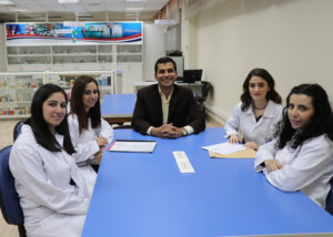 Mohamed Amin at a table with his students