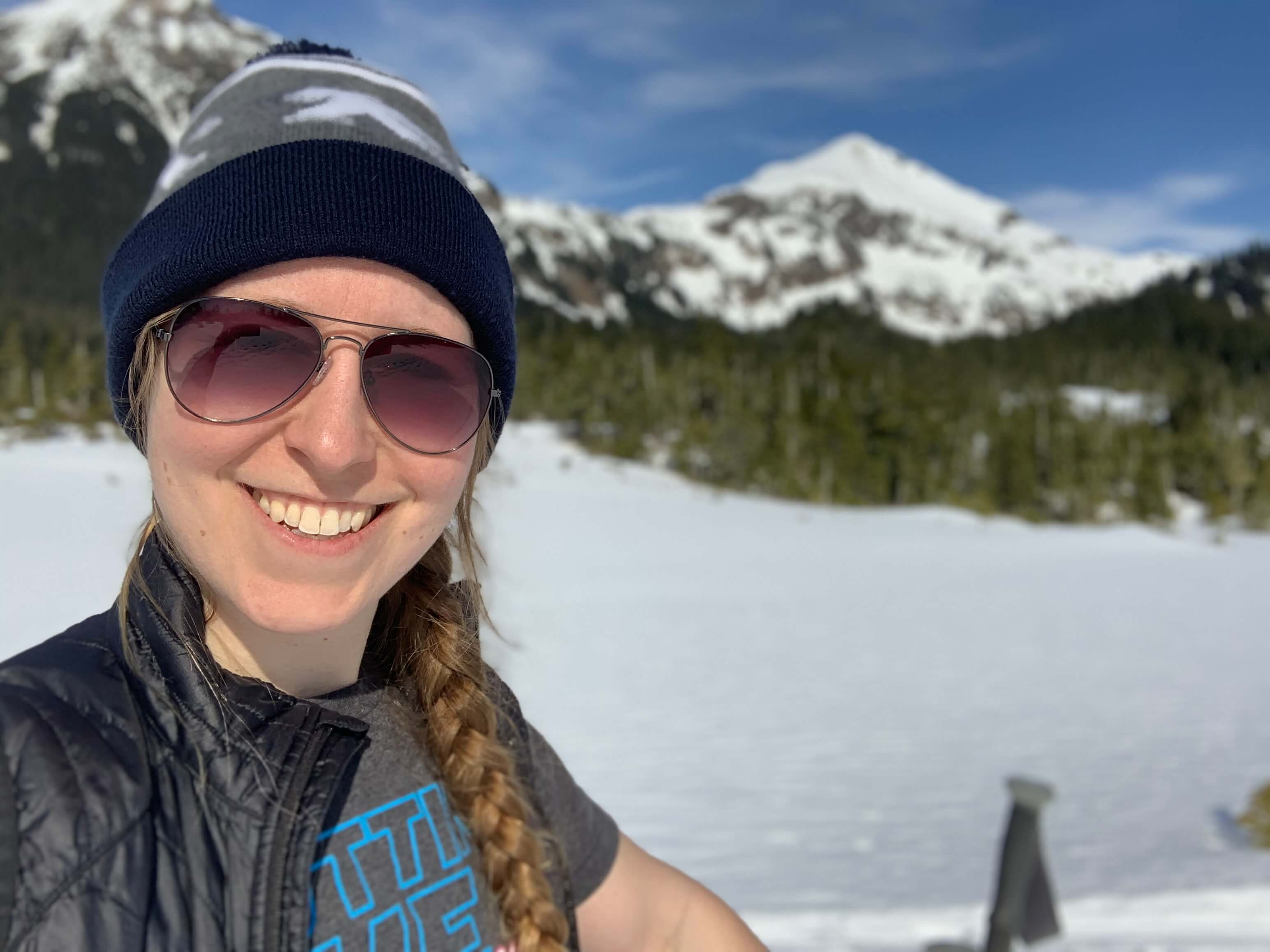 Heidi Voss taking a selfie with snowscapes behind her
