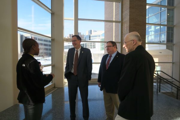 Cierra Brewer speaking to Provost Karl Scholz at the entrance of Rennebohm Hall with Steve Swanson and Ron Burnette