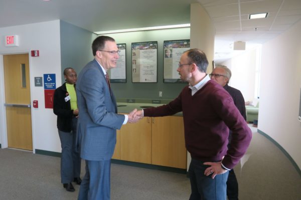 Provost Karl Scholz shaking hands with Tim Bugni