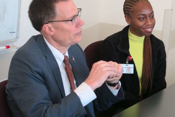 Provost Karl Scholz and Cierra Brewer sitting at a table