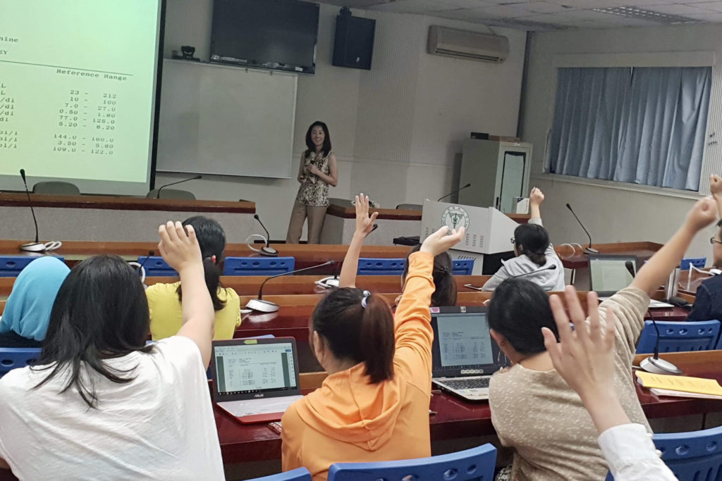 Michelle Chui in Taiwan speaking to a lecture hall of students from China Medical University