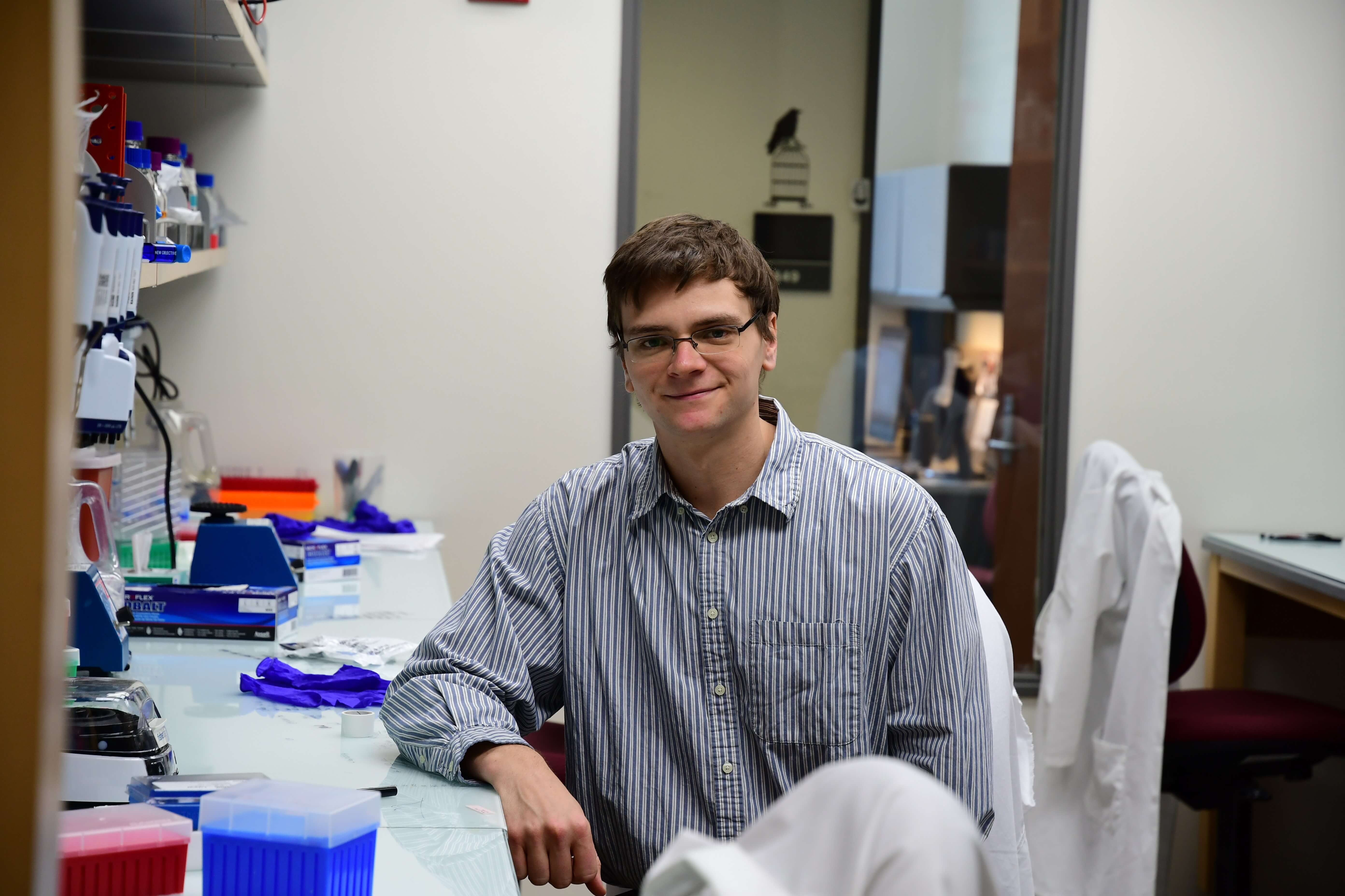 Ian Miller sitting in a lab