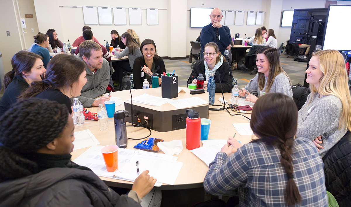 Health sciences students from pharmacy, nursing, and medicine work through an exercise to promote interprofessional collaboration