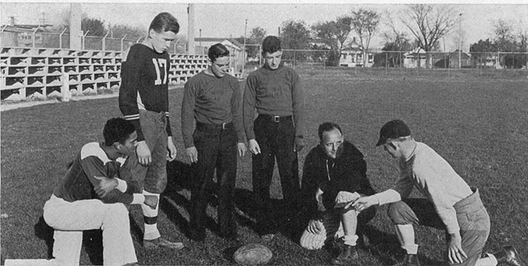 James Buchanan (left, kneeling) with the Menasha High School football coaching staff in 1934.