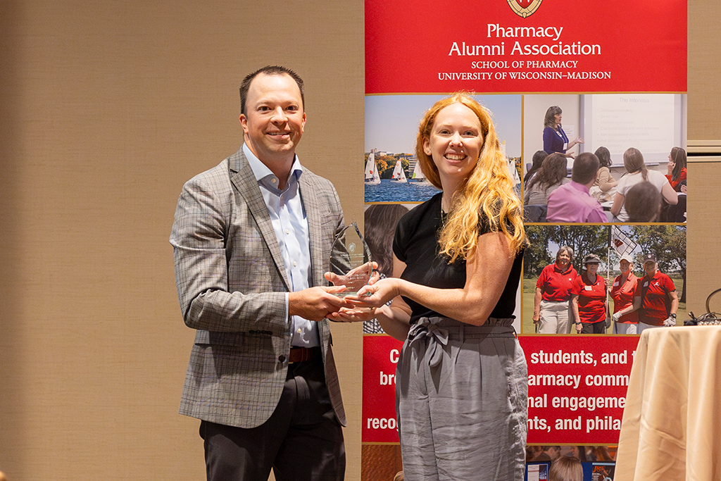 Heather Spatchek hands Jason Bergsbaken an award