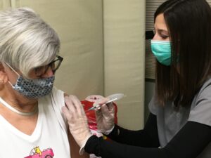 Jill Klay delivering a COVID-19 vaccine