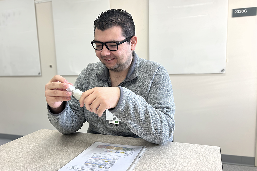 Joey Jimenez holding a white medical device in his hand