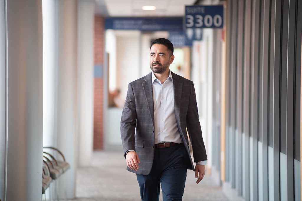 Nick Capote walks through a hospital hallway