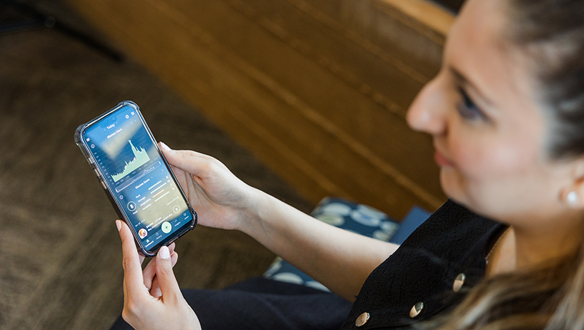 Paria Sanaty Zadeh looking at a glucose monitoring app on her phone