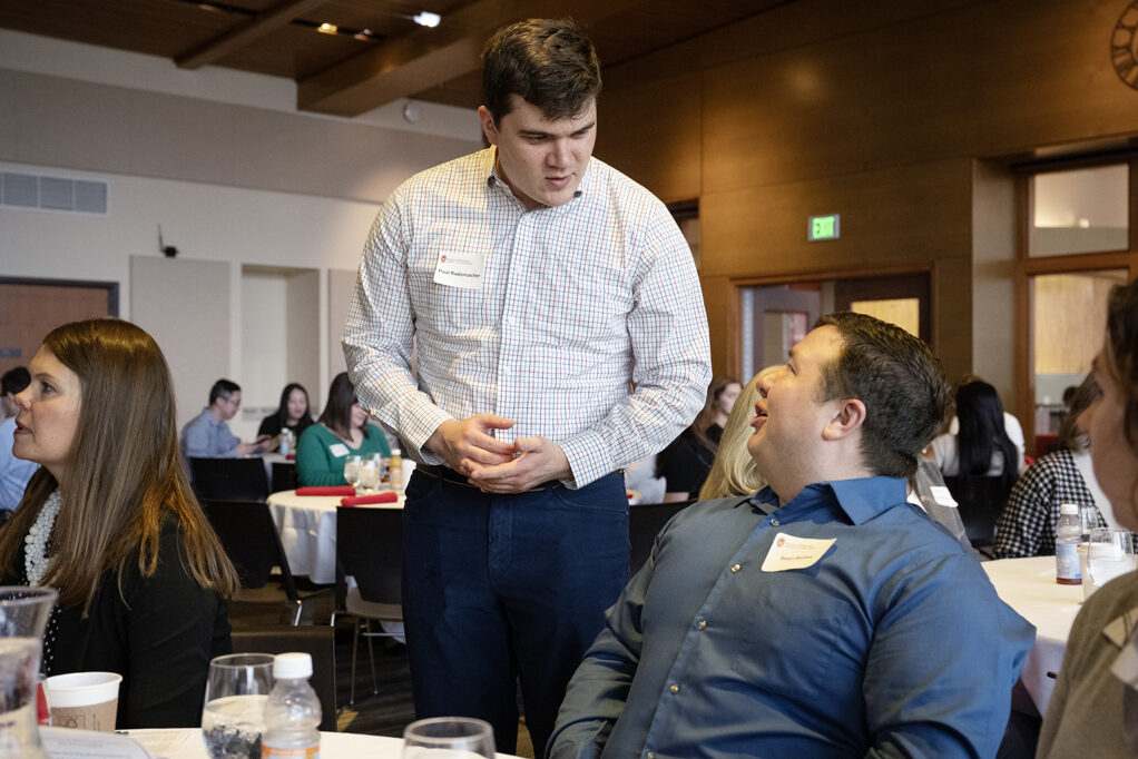 PharmD students speak at a table.