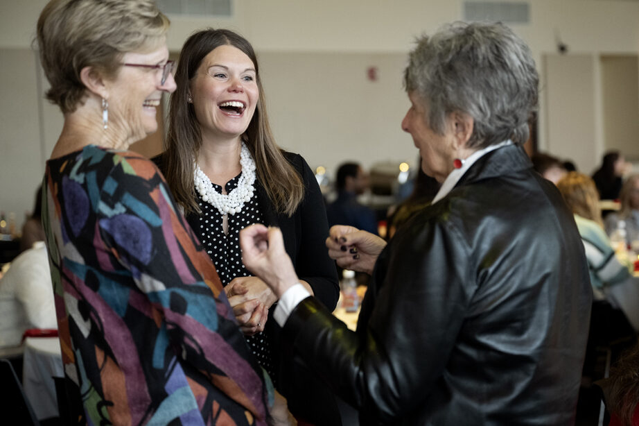 Andrea Porter and Pam Ploetz laugh with another attendee.