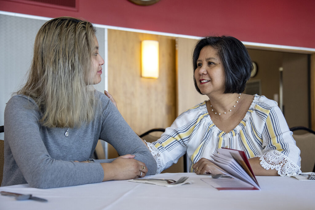 Ally Mahinay, a first-year PharmD student talks with her mother, Liza Mahinay, during the 2022 School of Pharmacy Scholarship Brunch