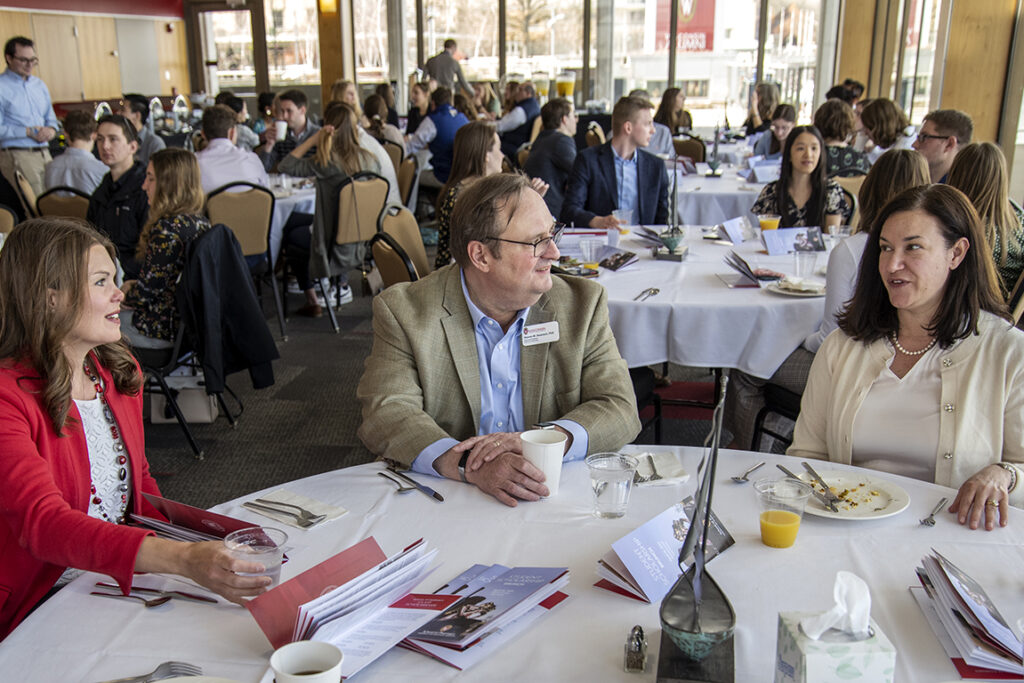 Dean Steve Swanson chats with Professor Andrea Porter and Julie Jensen, Director of Development at the School of Pharmacy, during the 2022 School of Pharmacy Scholarship Brunch at the Pyle Center