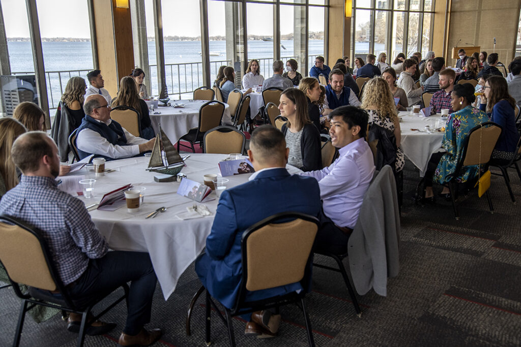 Students, family, and friends attend the 2022 School of Pharmacy Scholarship Brunch at the Pyle Center with a beautiful view of Lake Mendota.