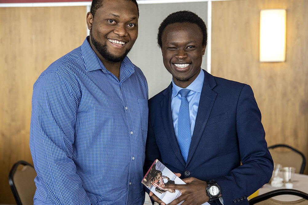Second-year PharmD students Michael Nome and Vincent Elijah pose for a photo op during the School of Pharmacy Scholarship Brunch on Sunday, April 10, 2022.