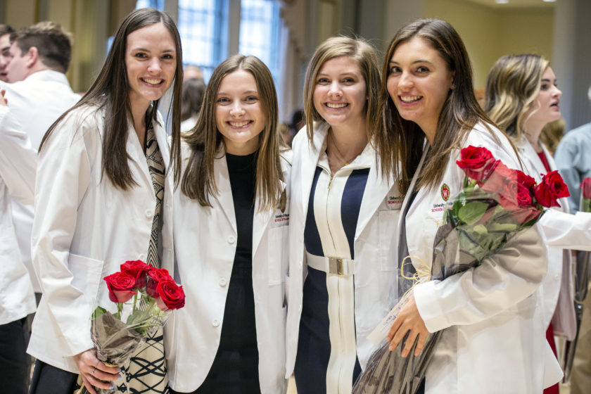 Students together in white coats after white coat ceremony