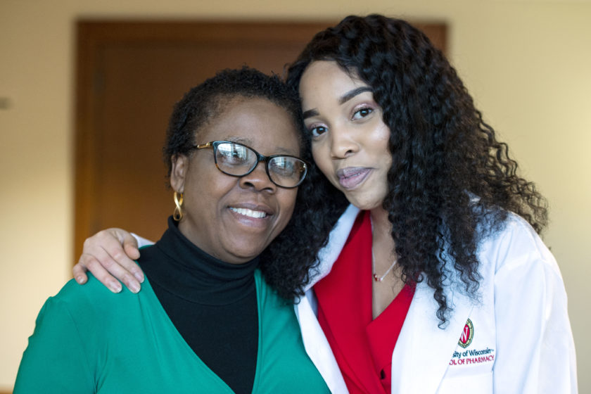 Student in a white coat with their mother after white coat ceremony