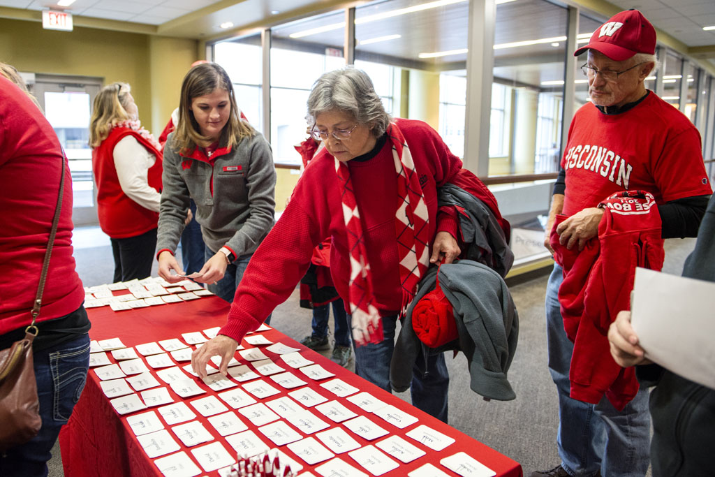 Alumni checking into the UW-Madison Pharmacy Alumni Tailgate event, held at Union South during the Badgers vs. Cornhuskers game.