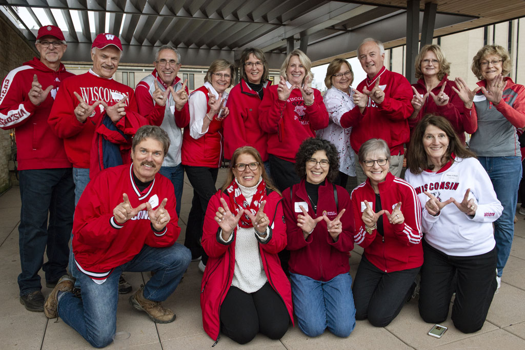 The Class of 1978 holding up the "W" for Wisconsin at the UW-Madison Pharmacy Alumni Tailgate event, held at Union South during the Badgers vs. Cornhuskers game.