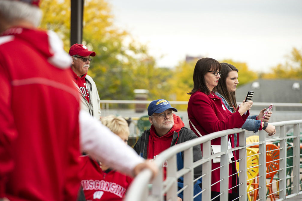 Alumni watching the Badger Band perform at the UW-Madison Pharmacy Alumni Tailgate event, held at Union South during the Badgers vs. Cornhuskers game.