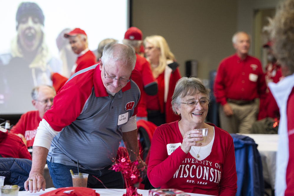 Alumni catching up at the UW-Madison Pharmacy Alumni Tailgate event, held at Union South during the Badgers vs. Cornhuskers game.