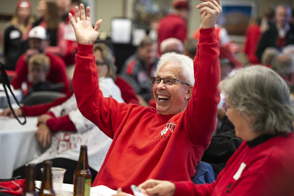 Bob Breslow celebrates a raffle win at the UW-Madison Pharmacy Alumni Tailgate event, held at Union South during the Badgers vs. Cornhuskers game.