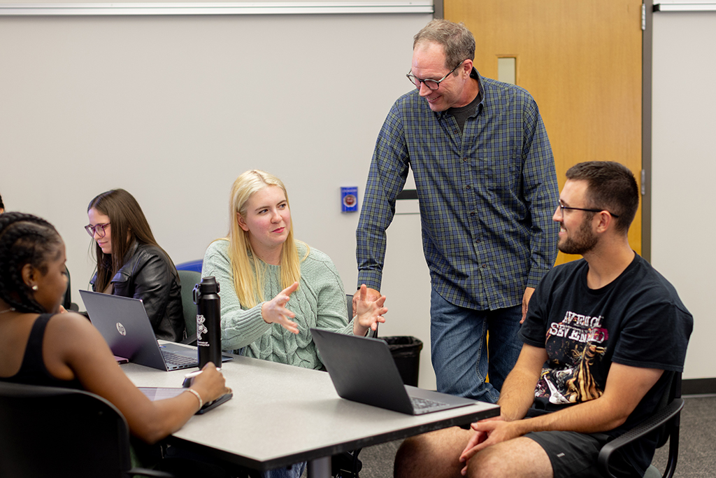 Pat Cory speaks with a group of students