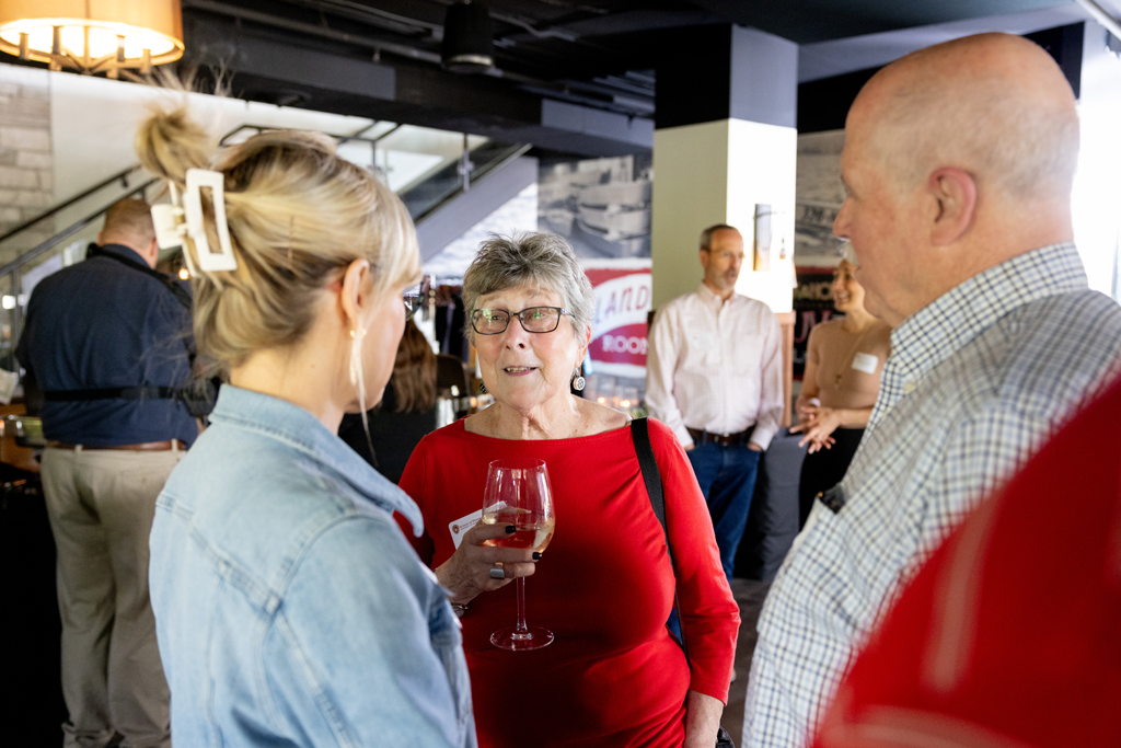 Beth Martin, Pam Ploetz, and Jim Demuth speak in a group