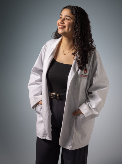 Reem, PharmD student in her white coat