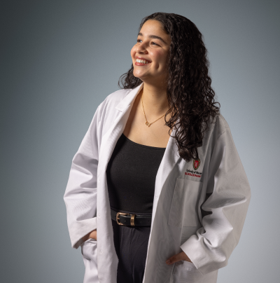 Reem, PharmD student in her white coat
