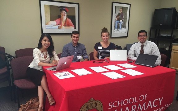 Students and staff running School of Pharmacy table