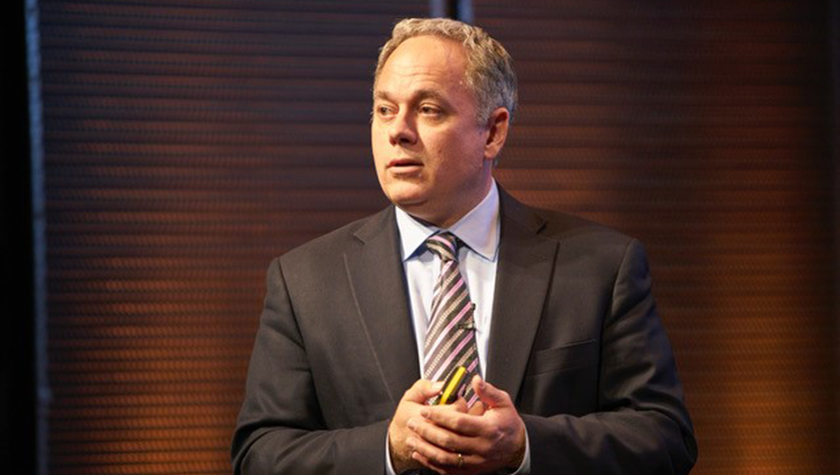 Rob Kowalski speaking onstage