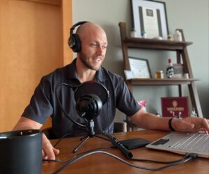 Ryan Feldman records a podcast in his home