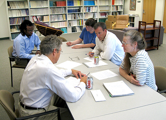 At an SRC meeting, Dale Wilson (dark blue short-sleeved shirt), Dave Mott, Betty Chewning, Dave Kreling and Henry Young sit around a table and discuss next steps.
