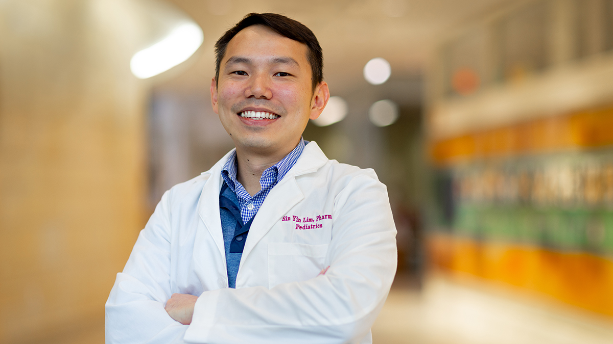 Sin Yin Lim poses in his white coat