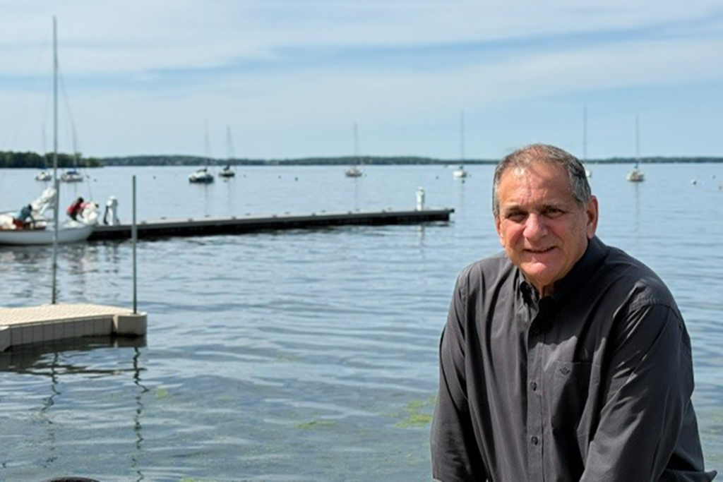 Steven Marcus smiles by the lake
