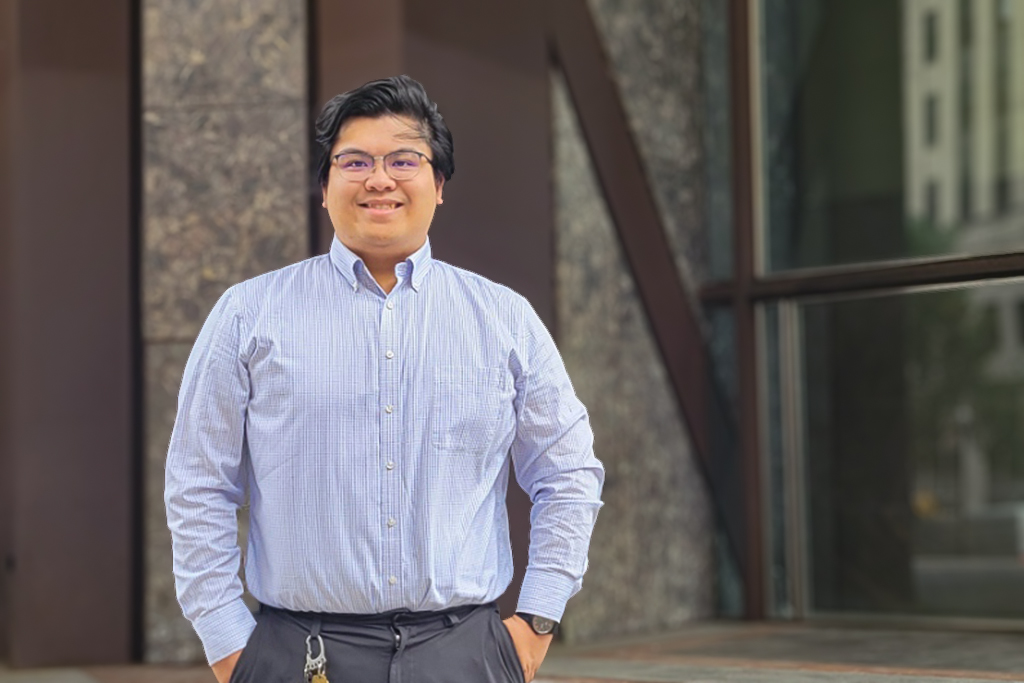 Steven Do stands in front of an office building