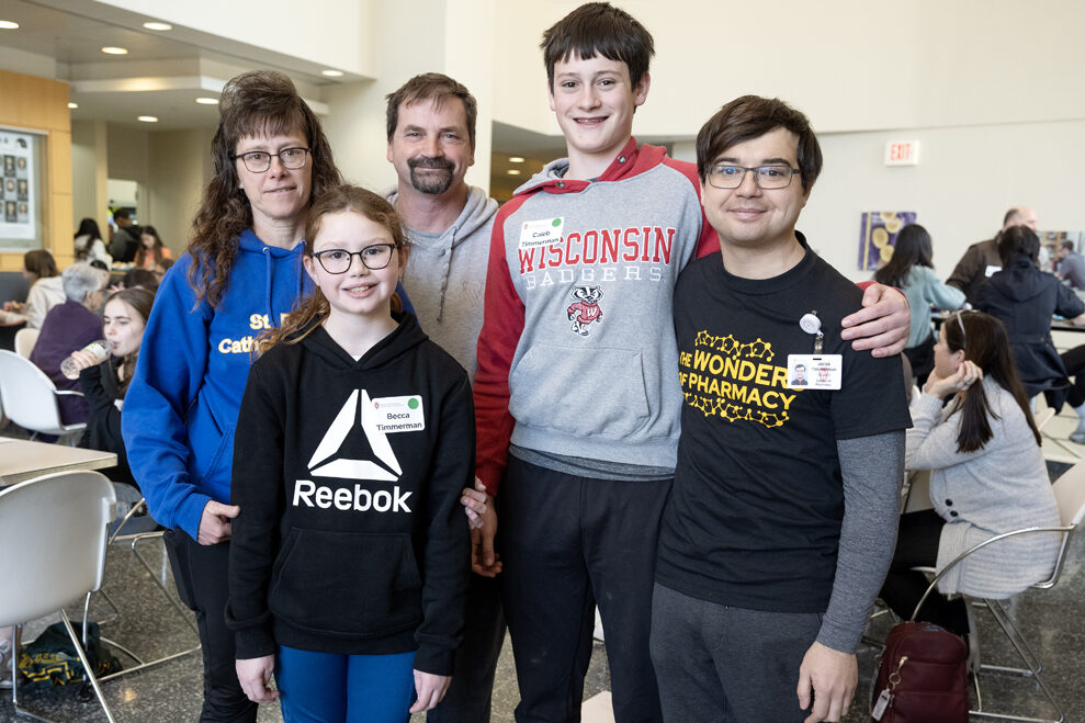 PharmD student Jacob Timmerman (far right) grabs a family photo with his family during the Wonders of Pharmacy activities on Saturday, March 2, 2024, at the School of Pharmacy on the campus of UW-Madison. (Photo Paul L. Newby, II) (Ids: Mother Karla, Sister Becca, Dad Todd, and Brother Caleb)