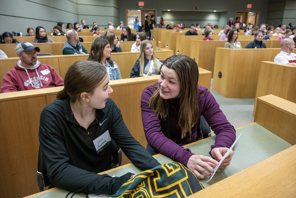 High schoolers Lizzy Mesenberg and Alexa Vesely look over the activities during the Wonders of Pharmacy on Saturday, March 2, 2024, at the School of Pharmacy on the campus of UW-Madison. (Photo Paul L. Newby, II)