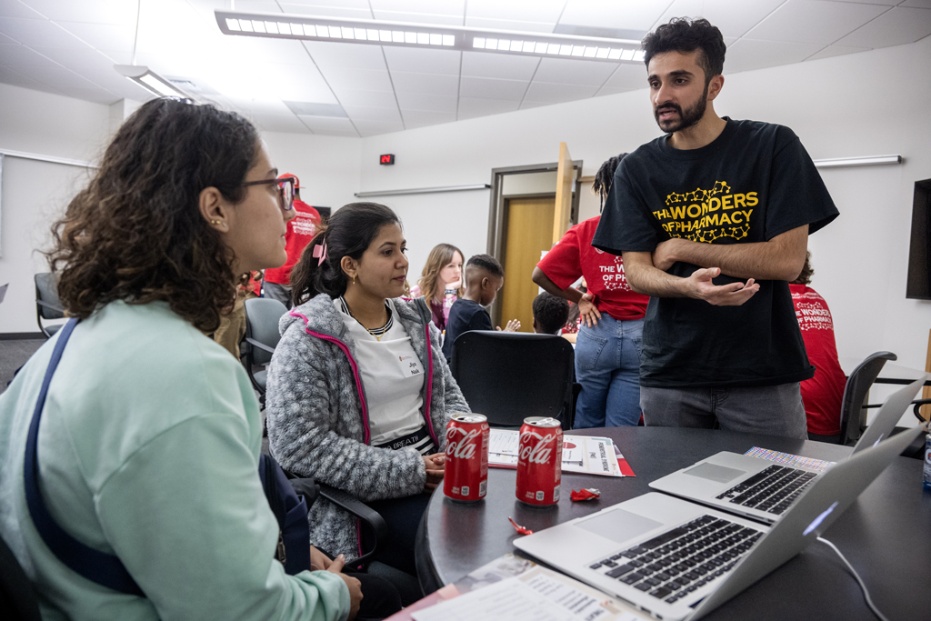 Third-year PharmD student Talha Mohammad chats with (l to r) Jana Alhuniti and Jiya Naik about the MEDSMART: Adventures in PharmaCity game during the Wonders of Pharmacy on Saturday, March 2, 2024, at the School of Pharmacy on the campus of UW-Madison. (Photo Paul L. Newby, II)