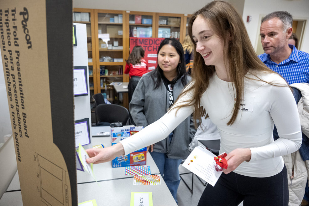 As her father, Bill Mueller, looks on, Ava Mueller tries her luck as she plays The Drug Store Cowboys activity during the Wonders of Pharmacy on Saturday, March 2, 2024, at the School of Pharmacy on the campus of UW-Madison. (Photo Paul L. Newby, II)