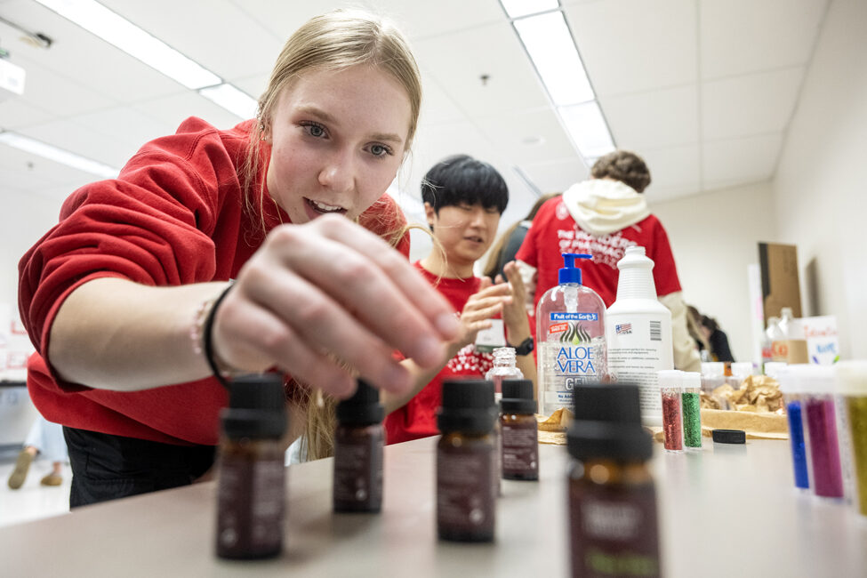 Brooke Siebert reads the different types of scents for her hand sanitizer while trying out the Compounding Crazies activity during the Wonders of Pharmacy on Saturday, March 2, 2024, at the School of Pharmacy on the campus of UW-Madison. (Photo Paul L. Newby, II)